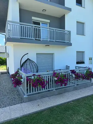 a building with purple flowers on a balcony at Apartman Verdure in Bihać