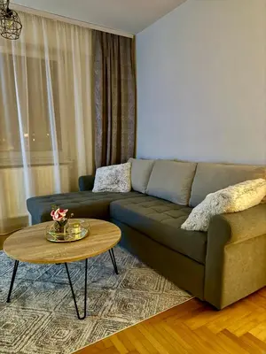 a living room with a couch and a table at Apartmani Alexa in Banja Luka