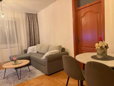 a living room with a couch and a table at Apartmani Alexa in Banja Luka