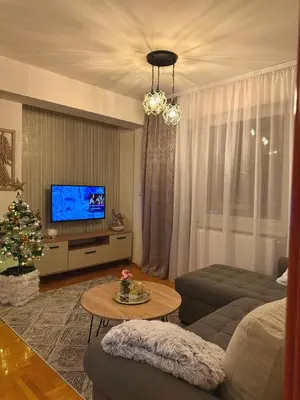 a living room with a couch and a television at Apartmani Alexa in Banja Luka