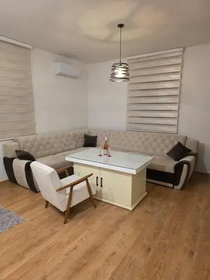 a living room with a couch and a table at Stan na dan -Lukavac in Lukavac