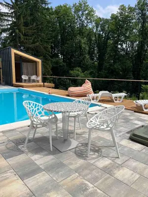 a patio with a table and chairs next to a pool at Šumska Duša in Banja Luka