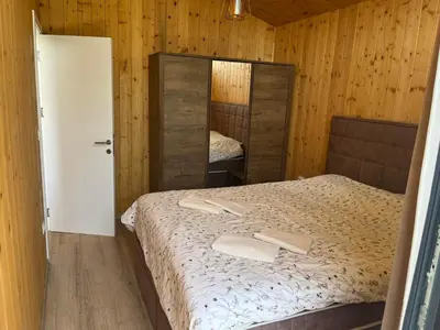 a small bedroom with a bed and a mirror at Šumska Duša in Banja Luka