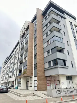 a large apartment building with a car parked in front at Apartman Gak 2 in Banja Luka