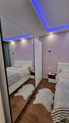 a room with two beds with mirrors and rugs at Apartman Gak 2 in Banja Luka