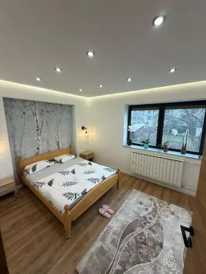 a bedroom with a large bed and a window at Apartman Hendek Tuzla in Tuzla