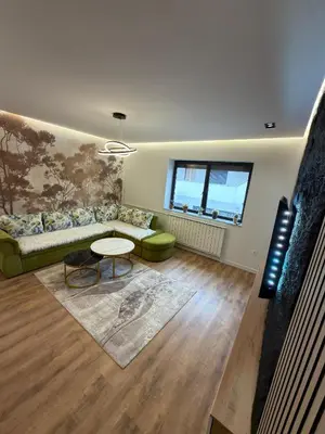a living room with a couch and a table at Apartman Hendek Tuzla in Tuzla