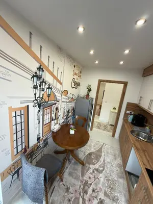 a kitchen with a table and a dining room at Apartman Hendek Tuzla in Tuzla