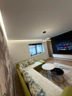 a living room with a couch and a table at Apartman Hendek Tuzla in Tuzla