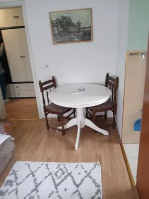 a white table and chairs in a room at Retro-Apartman in Prijedor