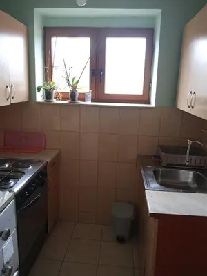 a small kitchen with a sink and a window at Retro-Apartman in Prijedor