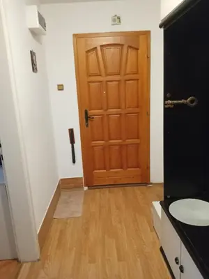 a hallway with a wooden door in a room at Retro-Apartman in Prijedor