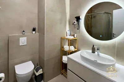 a bathroom with a sink and a mirror at ARIA Luxury Apartment, Tuzla in Tuzla
