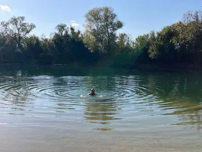 a person swimming in a large body of water at Large Modern House in Prijedor Bosnia Three Bedrooms Two Full Bathrooms Close to Zagreb EU Border Banja Luka Perfect for Bikers and Families in Prijedor