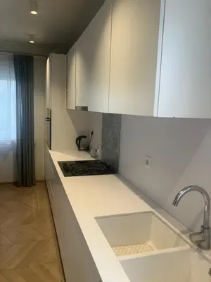 a kitchen with white cabinets and a sink at Large Modern House in Prijedor Bosnia Three Bedrooms Two Full Bathrooms Close to Zagreb EU Border Banja Luka Perfect for Bikers and Families in Prijedor