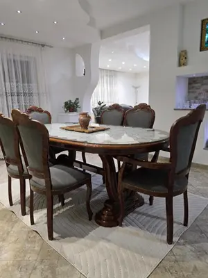 a dining room with a wooden table and chairs at Teo FAMILY APARTMENT TUZLA in Tuzla