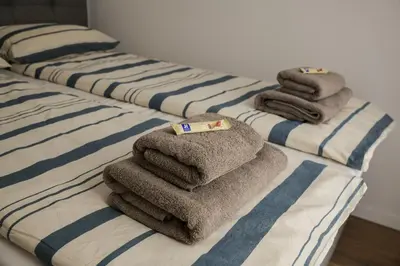 a pile of towels sitting on top of a bed at New City Nest - Tuzla Center in Tuzla
