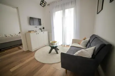 a living room with a couch and a table at New City Nest - Tuzla Center in Tuzla