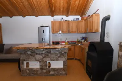 a kitchen with a stone counter and a stove at Vikendica Ivanović in Banja Luka