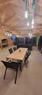 a dining room with a table and chairs in a room at Kuća za odmor River Nest