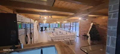a banquet hall with tables and chairs in a building at Kuća za odmor River Nest