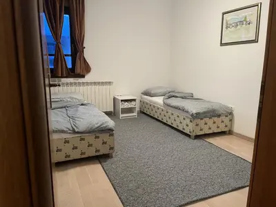 a room with two beds and a window at Grand Panorama Apartment in Fojnica