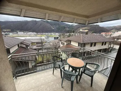 a balcony with a table and chairs and a view at Grand Panorama Apartment in Fojnica