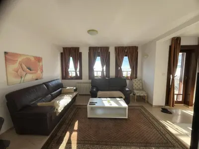 a living room with a couch and a coffee table at Grand Panorama Apartment in Fojnica