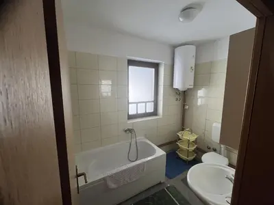 a bathroom with a tub and a toilet and a sink at Grand Panorama Apartment in Fojnica