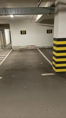 an empty parking lot with the numbers in a parking garage at Apartman s garazom in Banja Luka