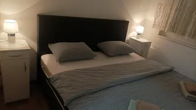 a bedroom with a bed with two pillows on it at Apartman s garazom in Banja Luka