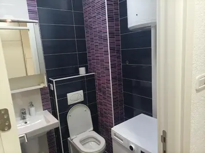 a small bathroom with a toilet and a sink at Apartman s garazom in Banja Luka