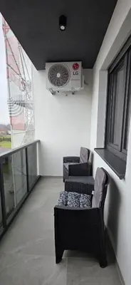 a living room with two chairs and a fan at Splendida in Bosanska Gradiška