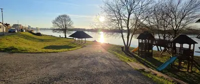 a path next to a body of water with a playground at Splendida in Bosanska Gradiška