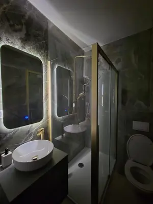 a bathroom with a sink and a toilet and a shower at Splendida in Bosanska Gradiška
