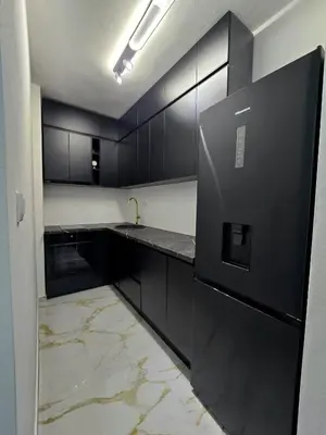 a kitchen with black cabinets and a black refrigerator at Splendida in Bosanska Gradiška