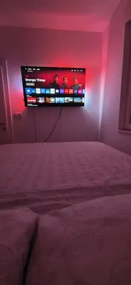 a bedroom with a bed with a tv on the wall at Splendida in Bosanska Gradiška
