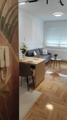 a living room with a couch and a table at Apartman Lena 51 BL in Železnička Stanica Incel
