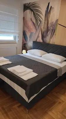 a large bed with towels on top of it at Apartman Lena 51 BL in Železnička Stanica Incel