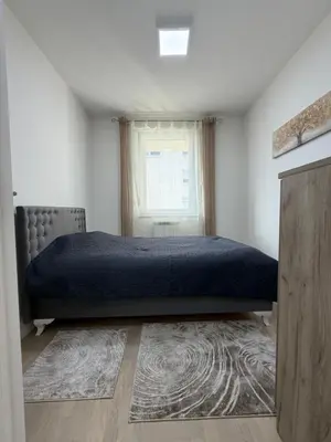 a bedroom with a bed and a window at Urban Home Stupine in Ši Selo