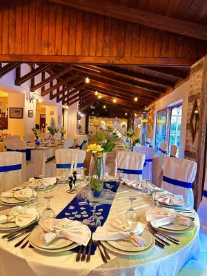 a dining room with white tables and white chairs at Motel Stovrela in Cazin