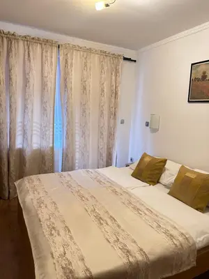 a bedroom with a bed and a window with curtains at Motel Stovrela in Cazin