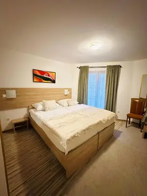 a large bedroom with a large bed and a window at Motel Stovrela in Cazin