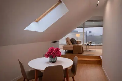 a living room with a table and chairs and a couch at BERLINA RESIDENCE Luxury Apartment in Bihać