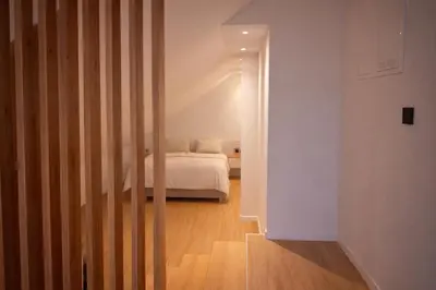 a room with a bed and a room with a door at BERLINA RESIDENCE Luxury Apartment in Bihać