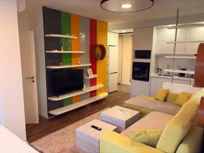 a living room with a couch and a tv at Stupine Relax Suite TUZLA in Tuzla