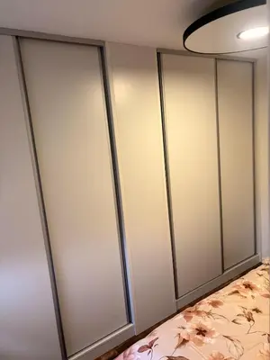 a row of glass wardrobes in a room at Stupine Relax Suite TUZLA in Tuzla