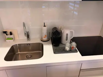a kitchen counter with a sink and a coffee maker at Stupine Relax Suite TUZLA in Tuzla