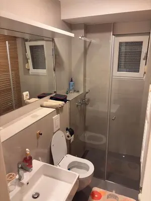 a bathroom with a shower and a toilet and a sink at Stupine Relax Suite TUZLA in Tuzla
