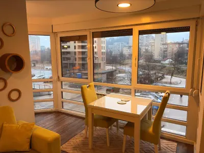 a room with a table and chairs and a large window at Stupine Relax Suite TUZLA in Tuzla